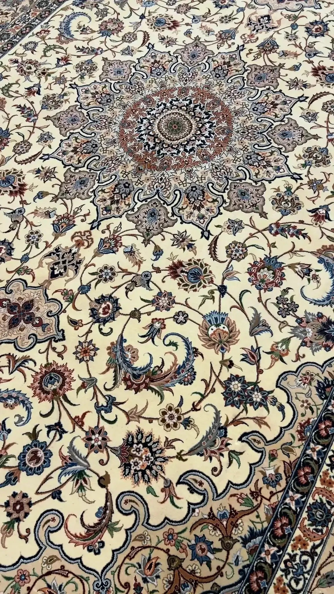 "Elegant Persian rug handcrafted by Ahmad Zojaji in Isfahan, Iran. Measuring 300 cm x 200 cm (9.8 x 6.5 feet), this stunning piece features a wool and silk pile, with a knot density of 810,000 knots per square meter. The intricate floral pattern and luxurious materials create a timeless addition to any space."